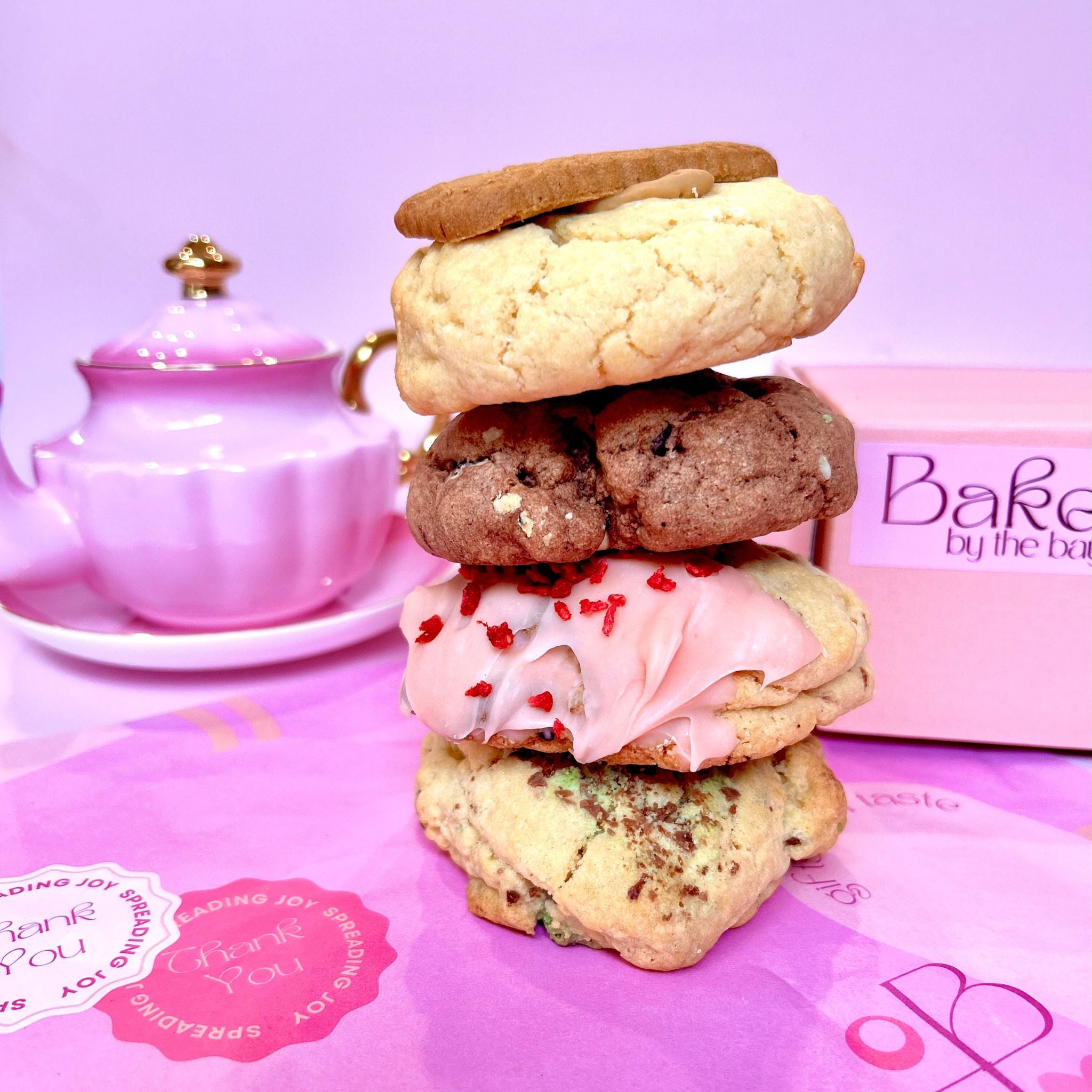 4 cookies stacked high on pretty pink tissue paper and a gift box ready for delivery australia wide
