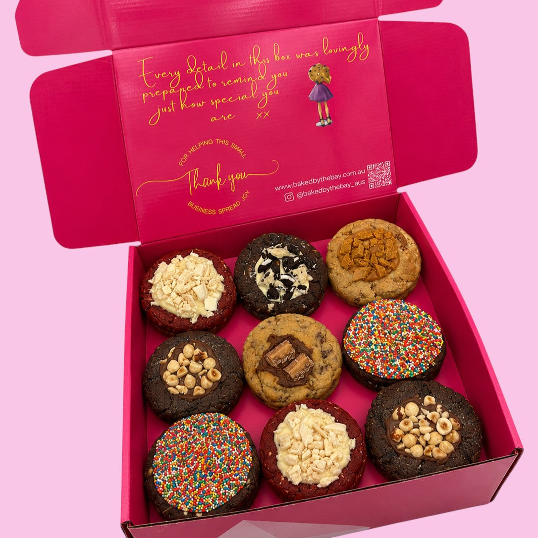 Box of assorted cookies with a pink box featuring text and a QR code on a pink background