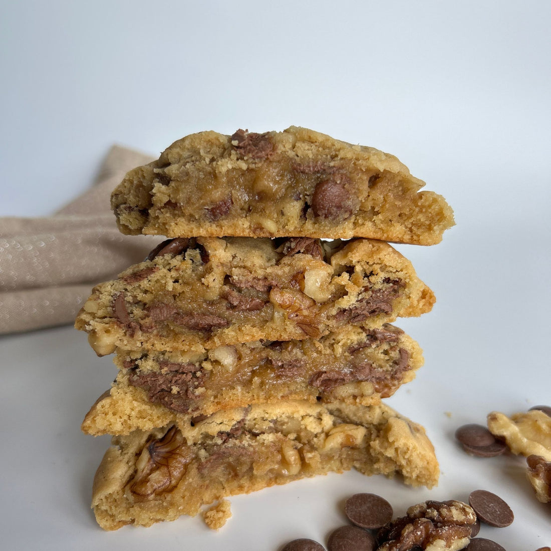 choc chip walnut cookies split in half showing delicious centre with melted chocolate