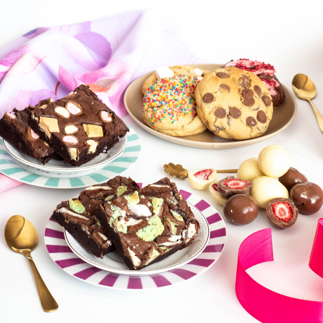A side view of desserts including chocolate brownies, handmade cookies and choc dipped strawberries