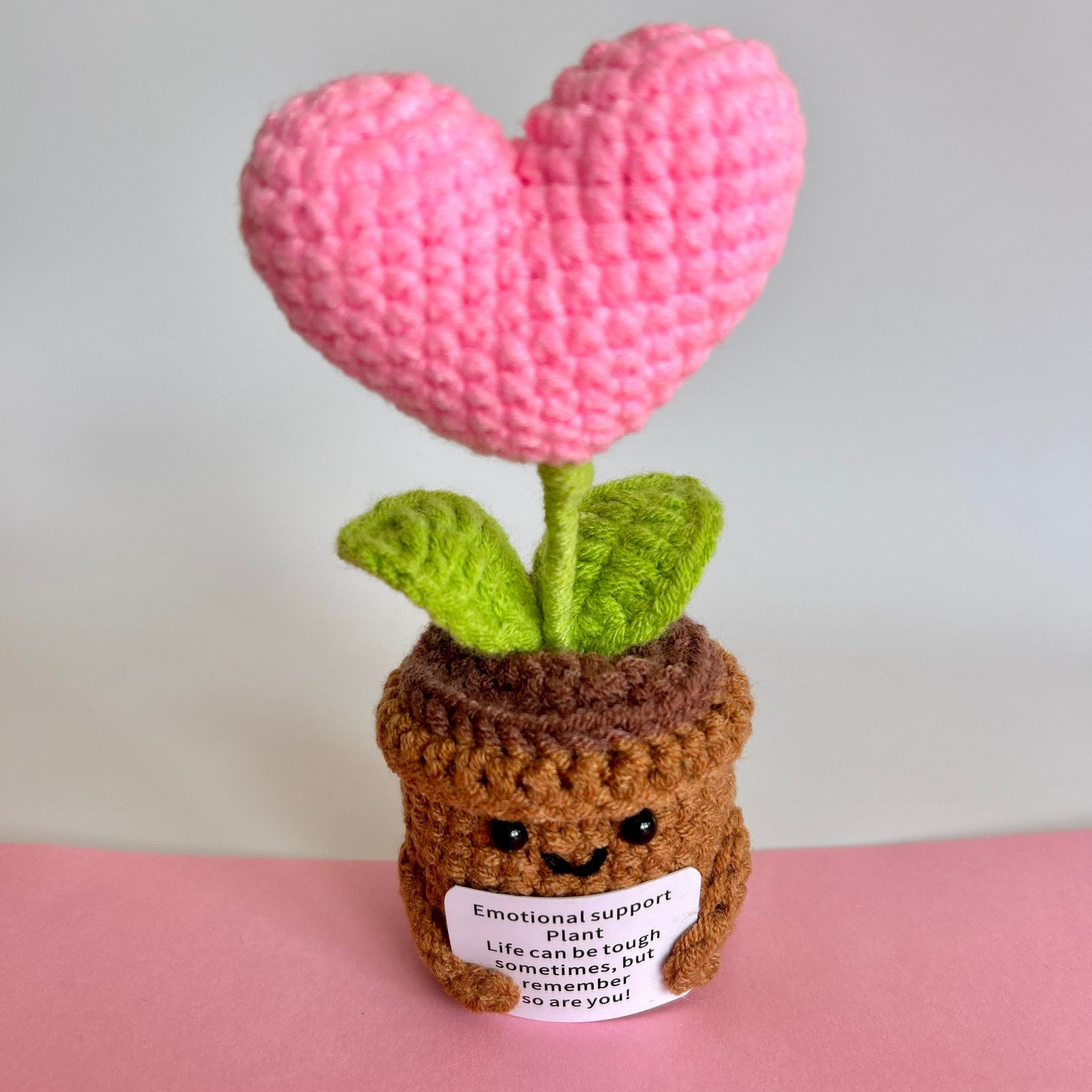 Hand knitted keepsake heart plant pink with message reading emotional support plant, life can be tough sometimes, but remember so are you!