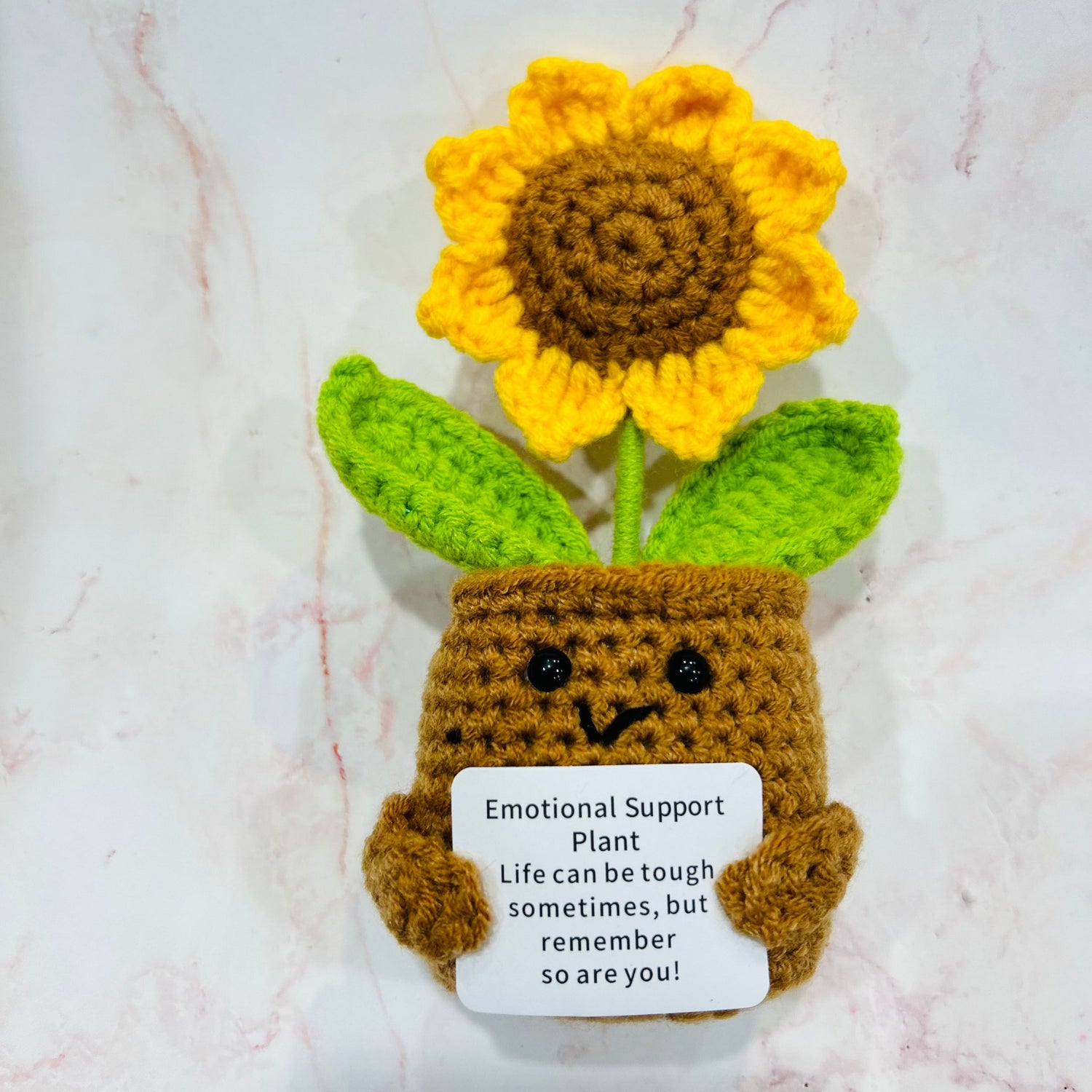 Front on view of hand knitted sunflower keepsake with message ready emotional support plant, life can be tough sometimes, but remember so are you!