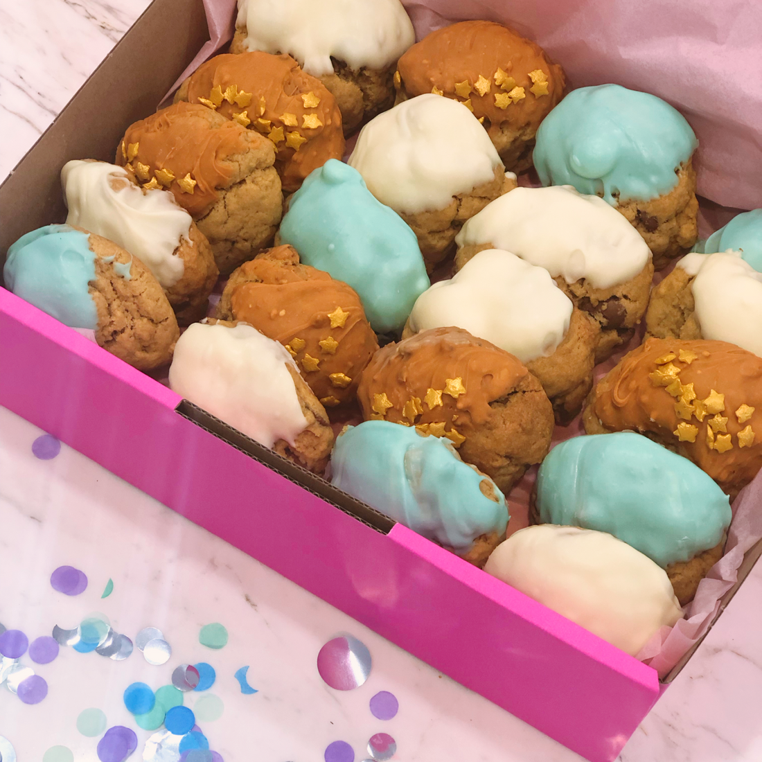 Pink box of gold, white and blue mini cookies ready for a party